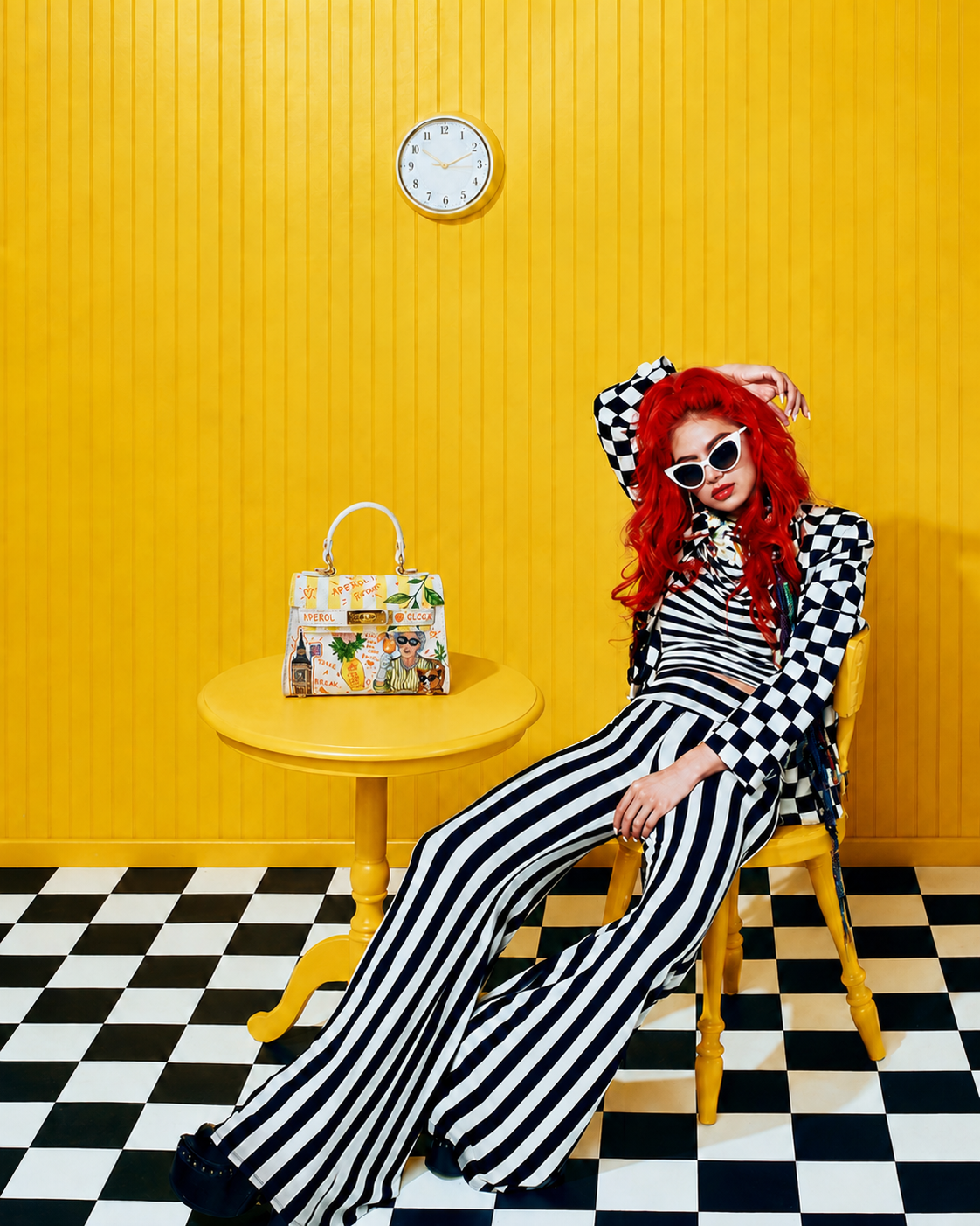 Woman in black and white beside an original painted leather bag
